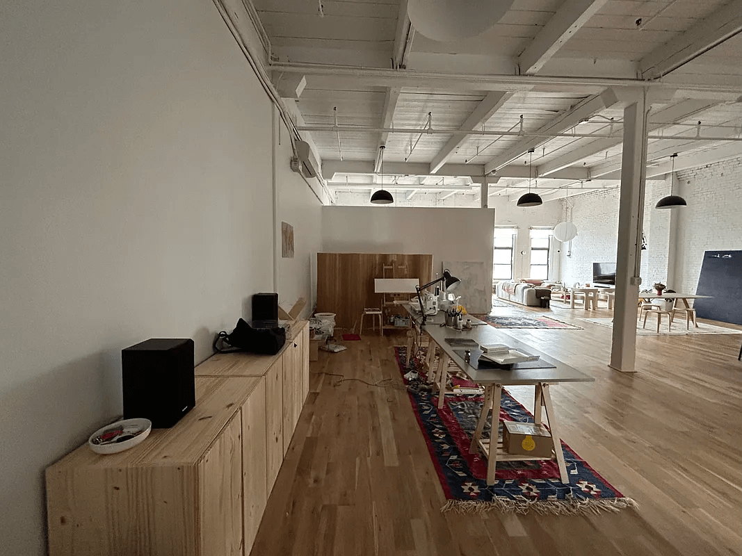 loft with wood floors and beamed ceiling