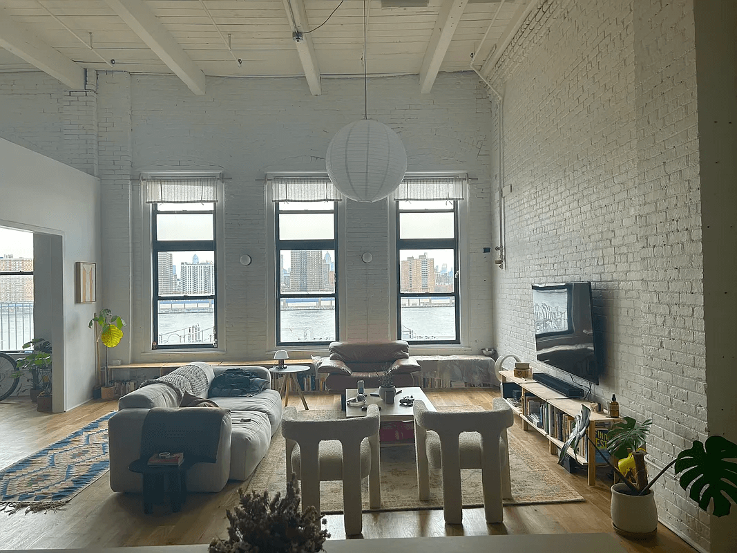 loft with brick walls and beamed ceilings