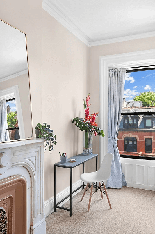 bedroom with mantel and carpet
