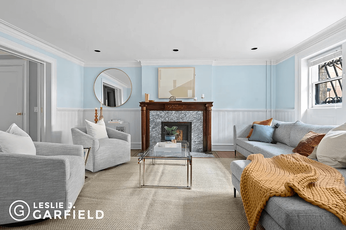 garden level front room with wainscoting and mantel