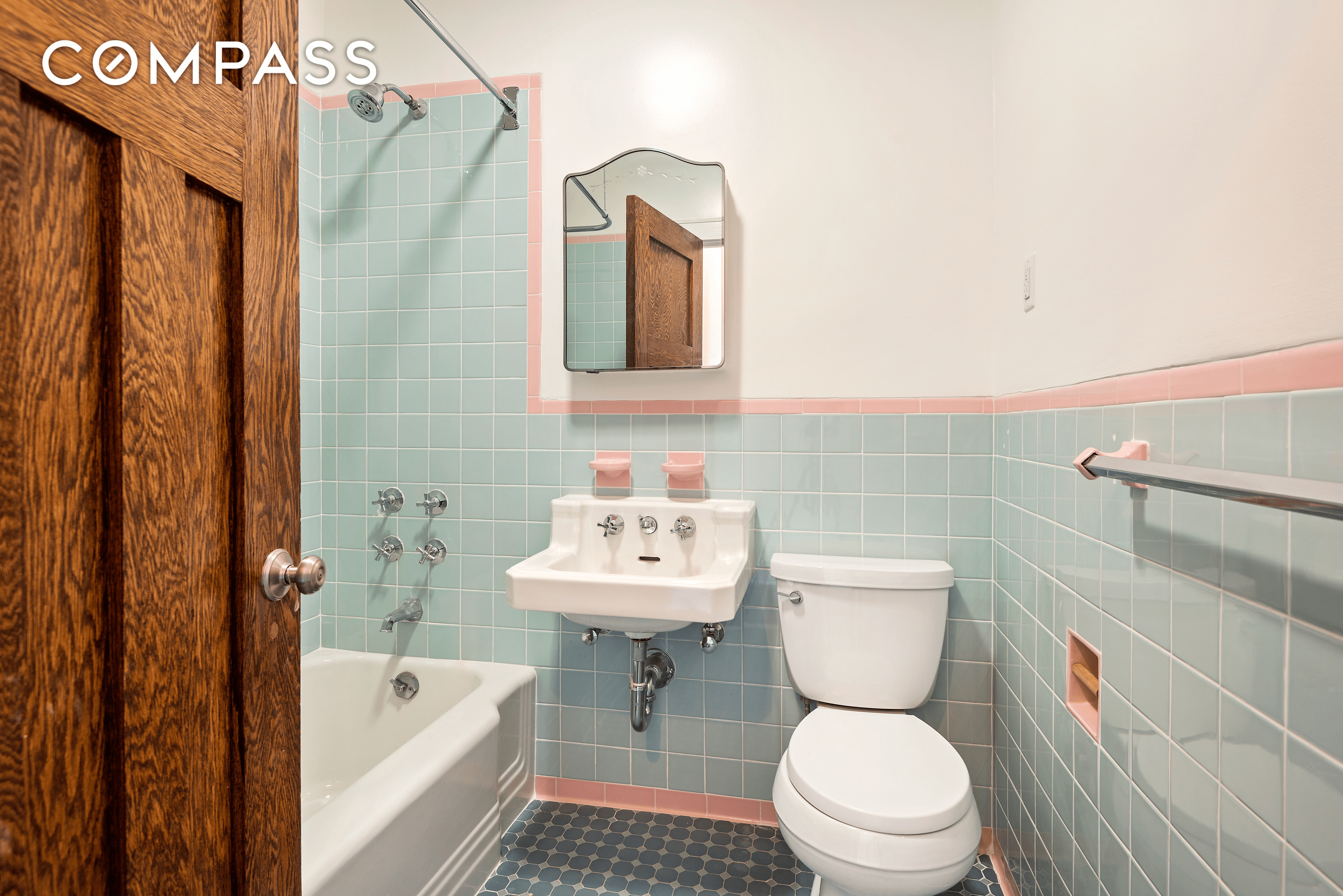 bathroom with art deco blue wall tile with pink border tile