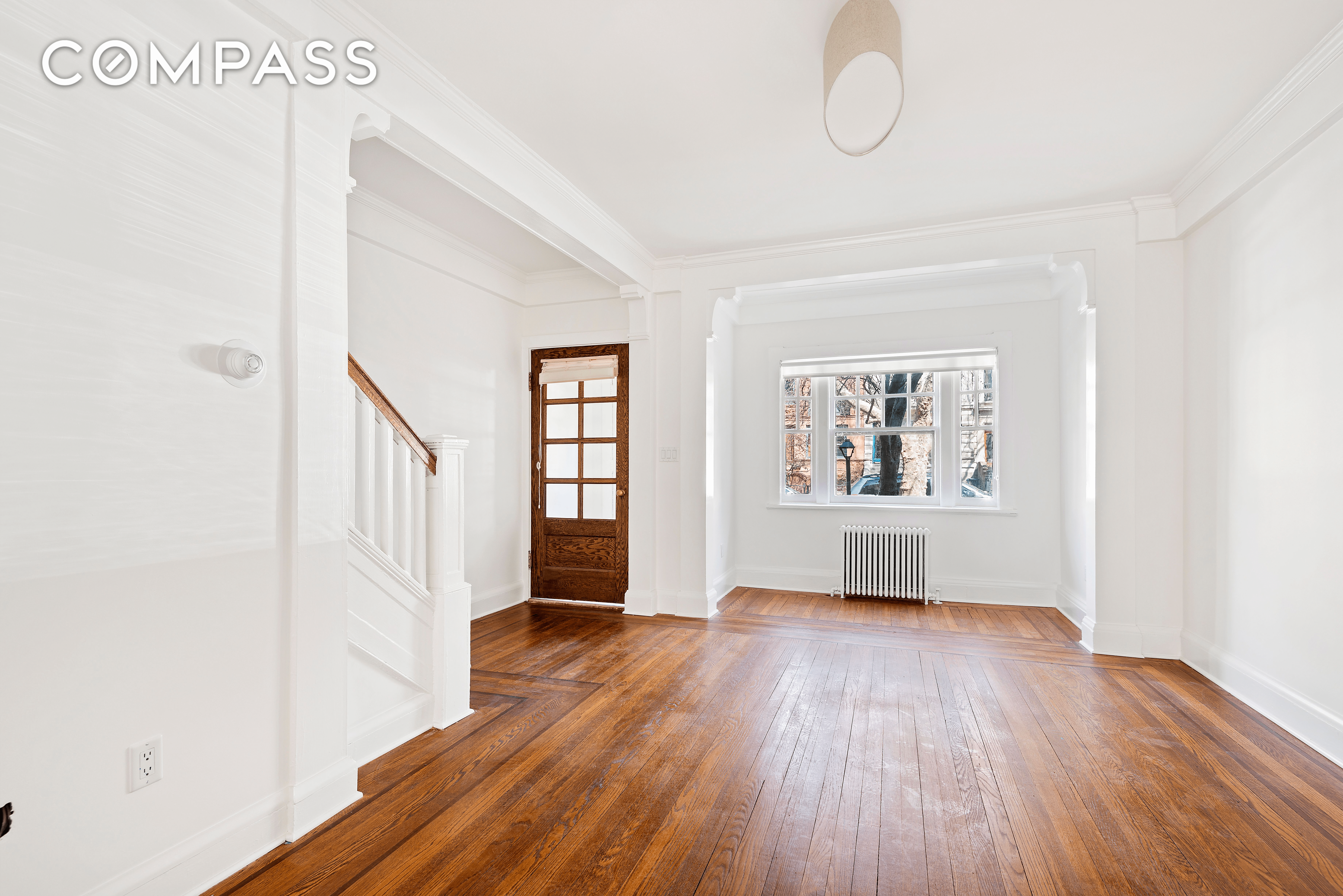 living room with stair and entry door