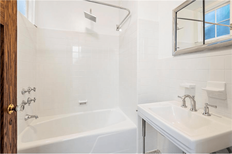 bathroom with white fixtures and wall tile