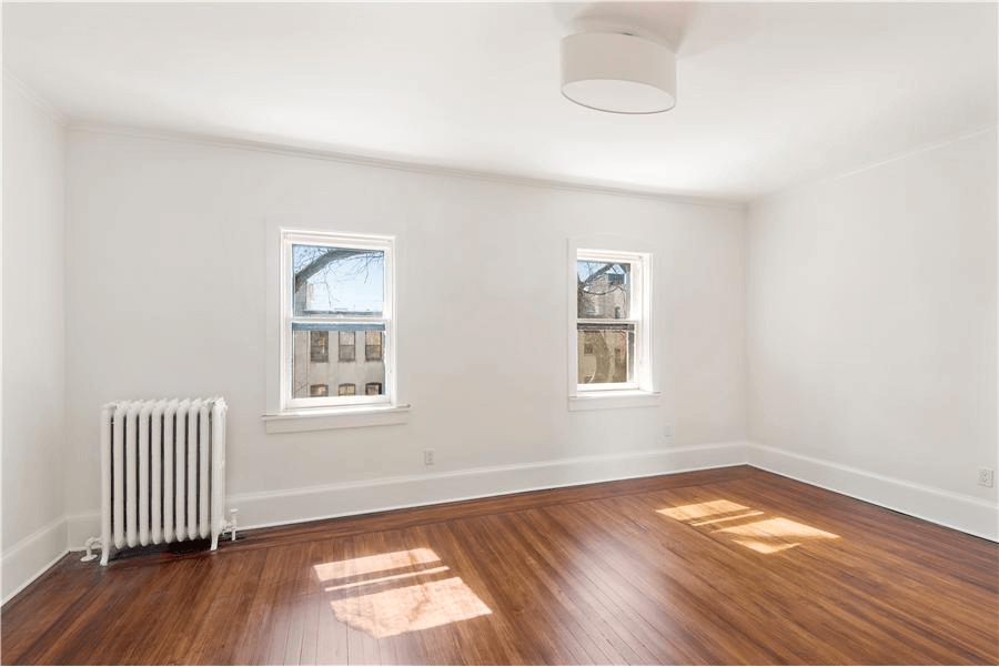 bedroom with wood floors and ceiling fixture