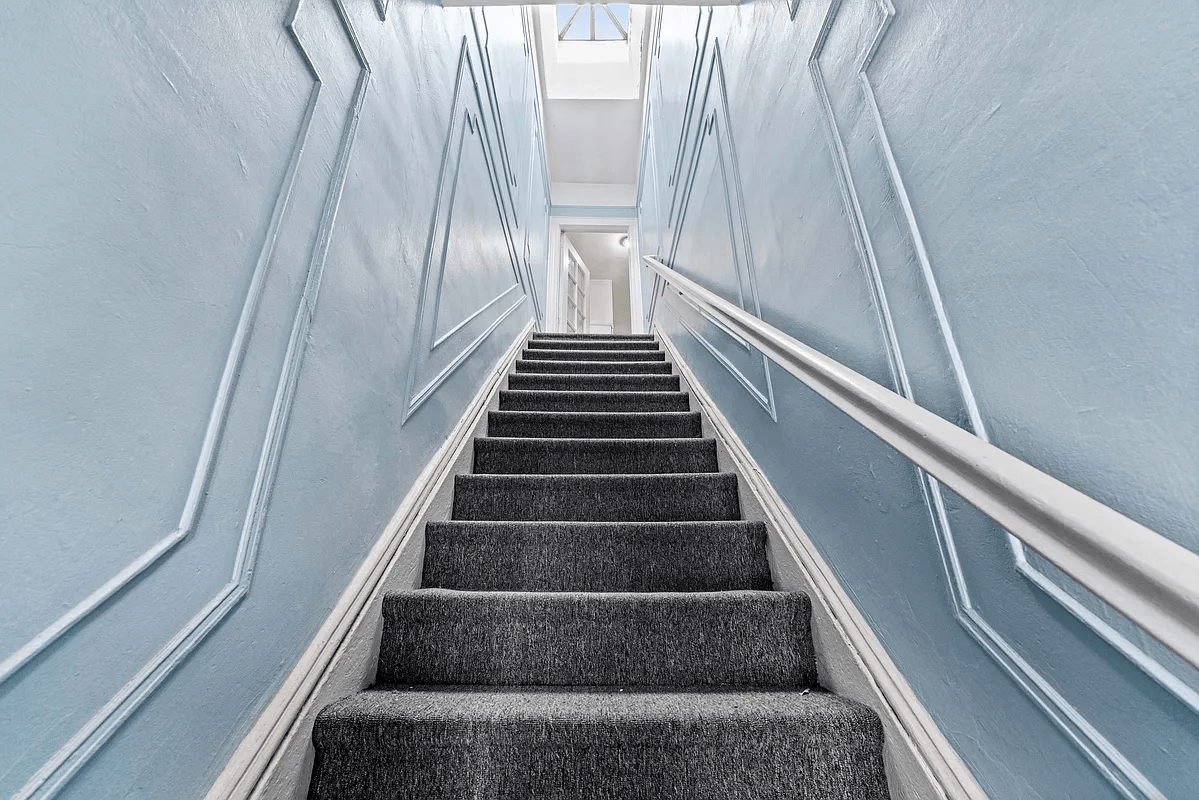 carpeted stairs to upper apartment