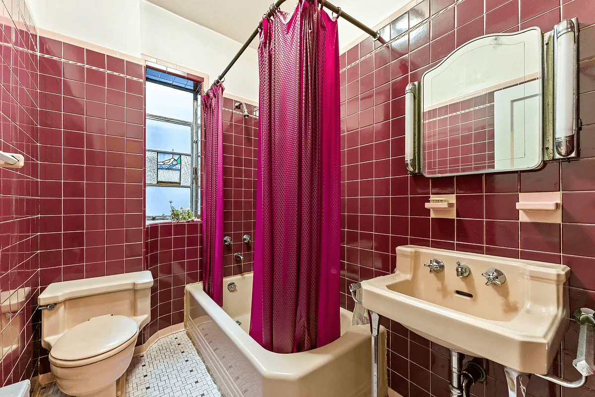 art deco bathroom with maroon wall tile and pink fixtures