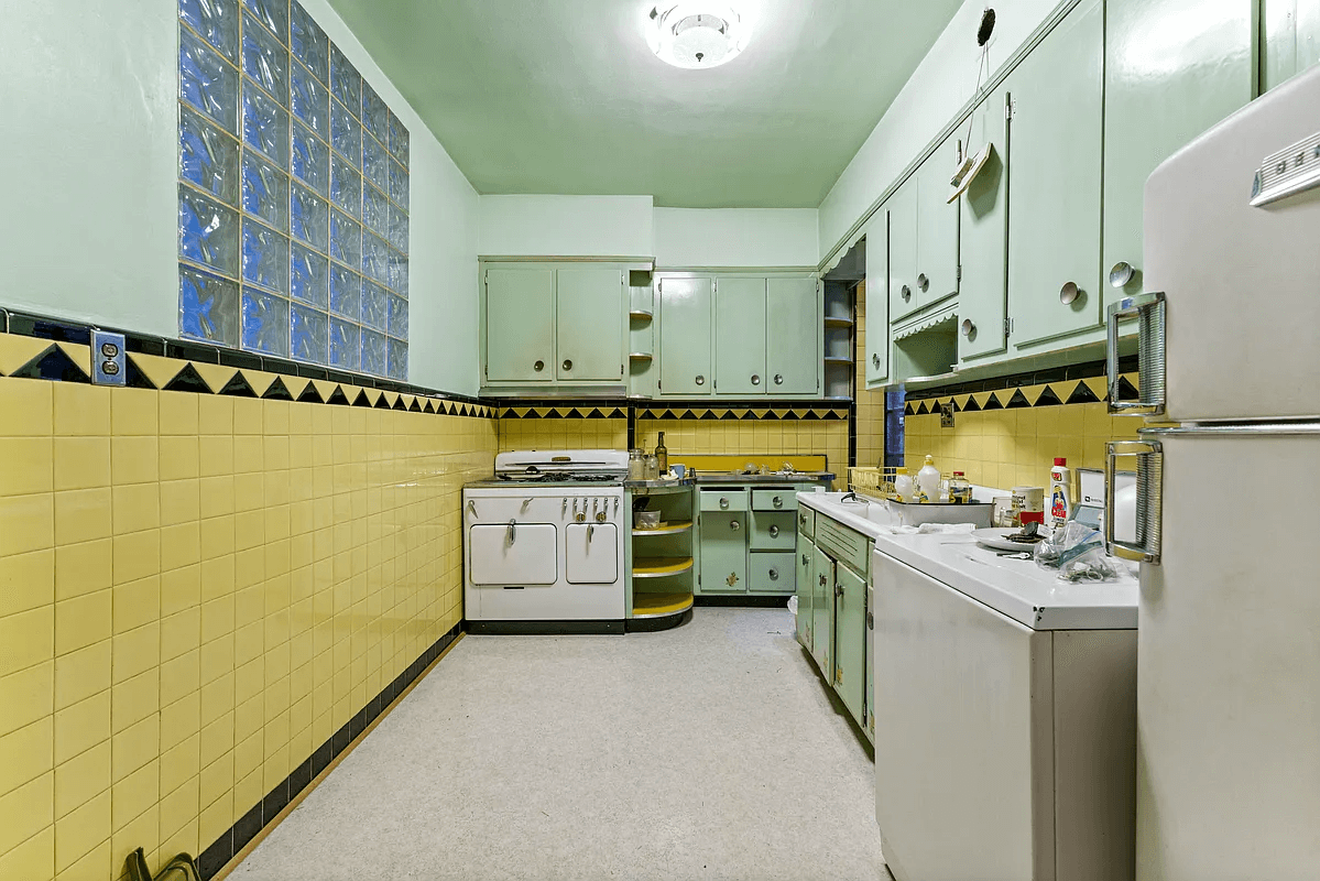 art deco kitchen with green cabinets and yellow wall tile