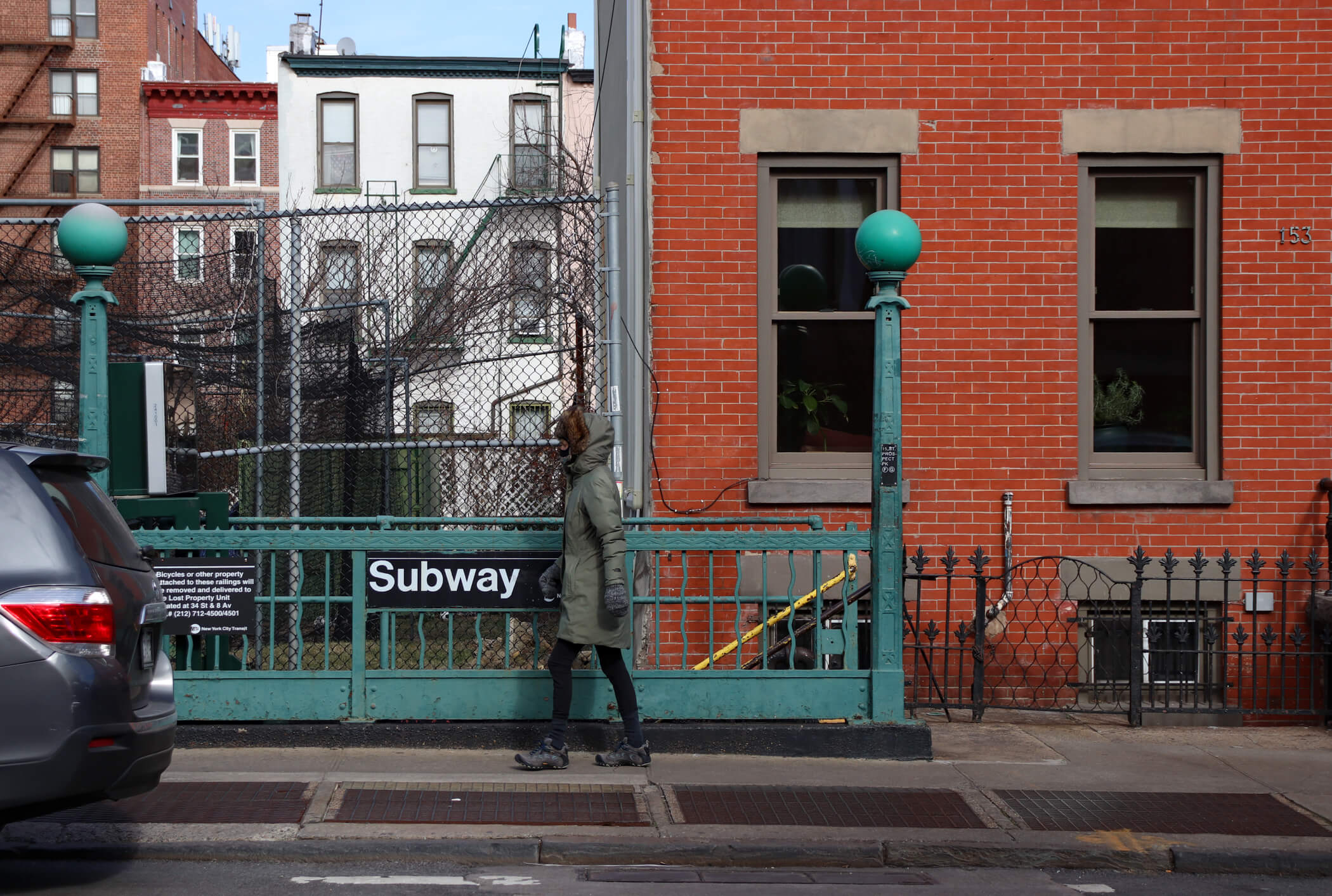 pedestrian walking past a subway station