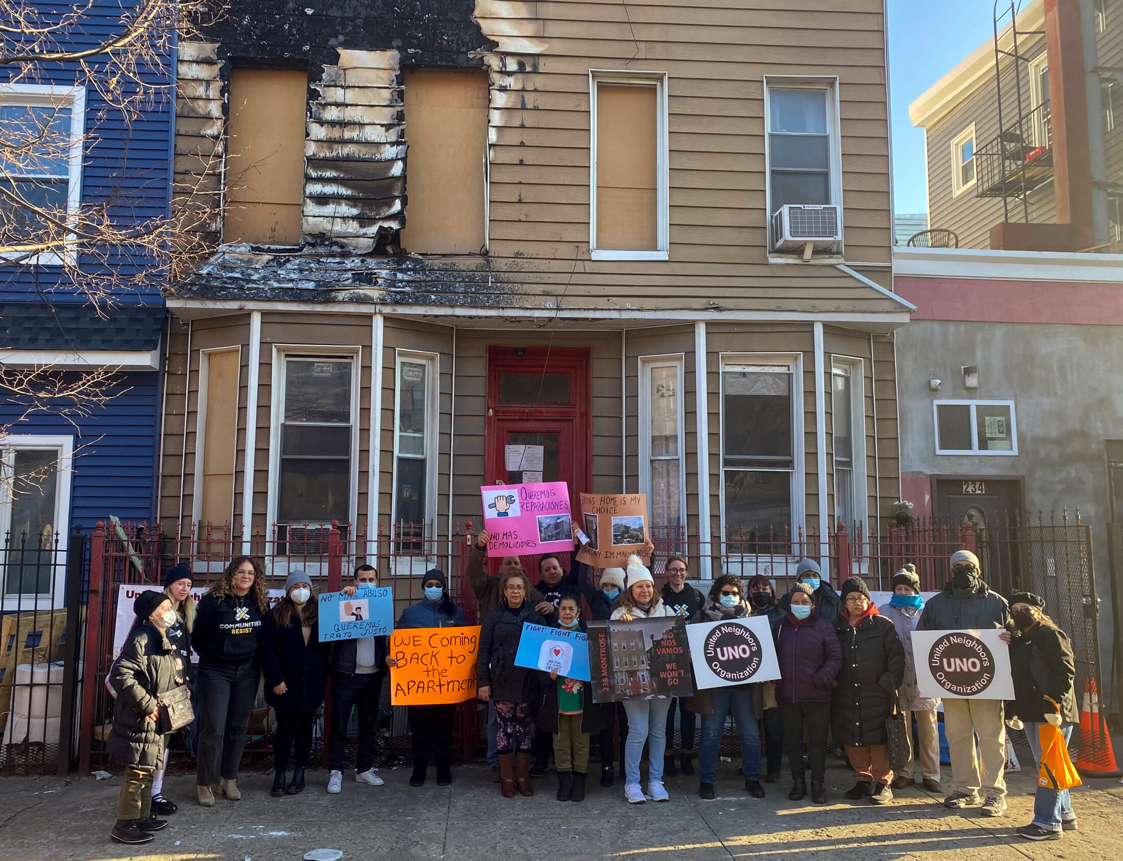 rally outside charred house