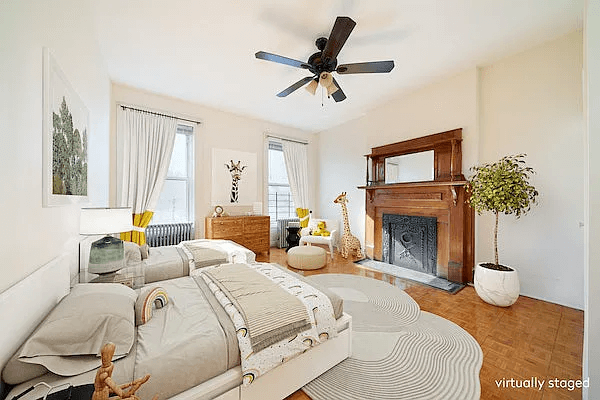 staged bedroom with wood mantel with mirror