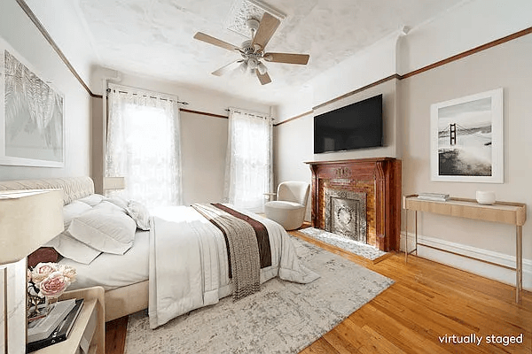 staged bedroom with wood mantel and ceiling medallion
