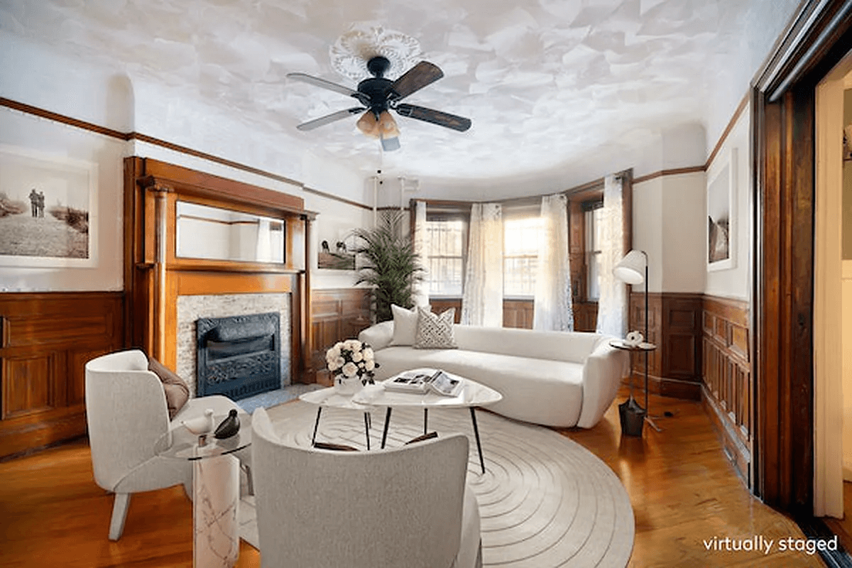 garden level dining room with mantel staged as a living room