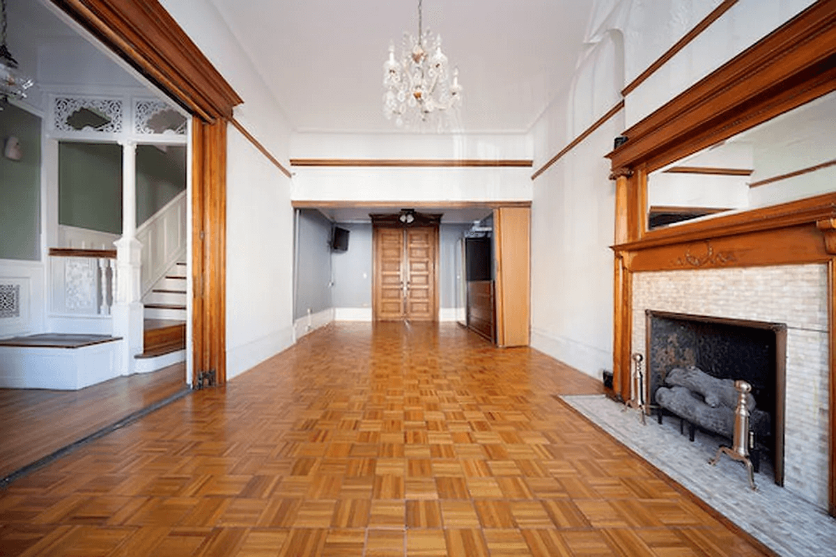 parlor with mantel and view to fretwork in entry