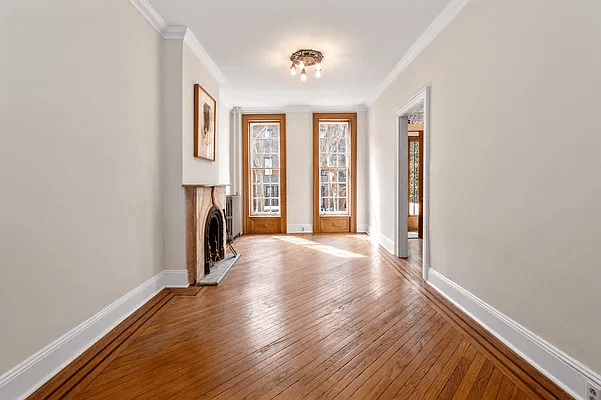 parlor with wood floors and marble mantel