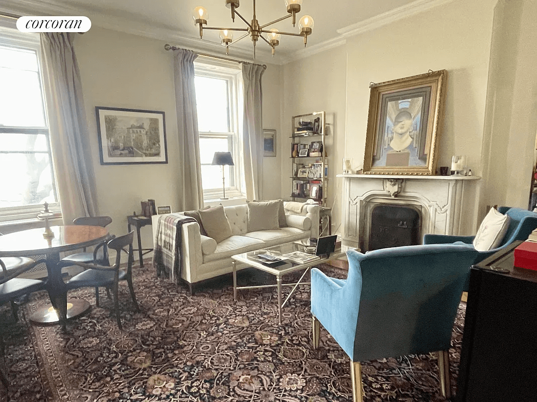 living room with high ceilings and marble mantel