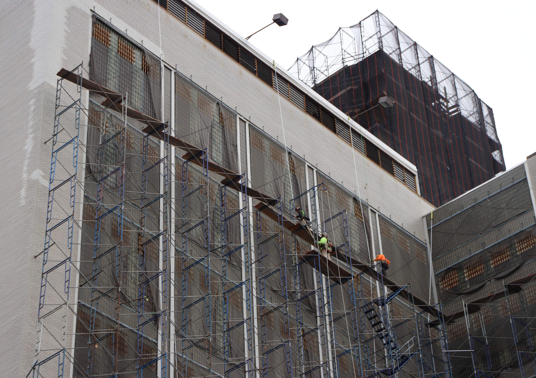 workers on scaffolding on the exterior of the Brooklyn House of Detention