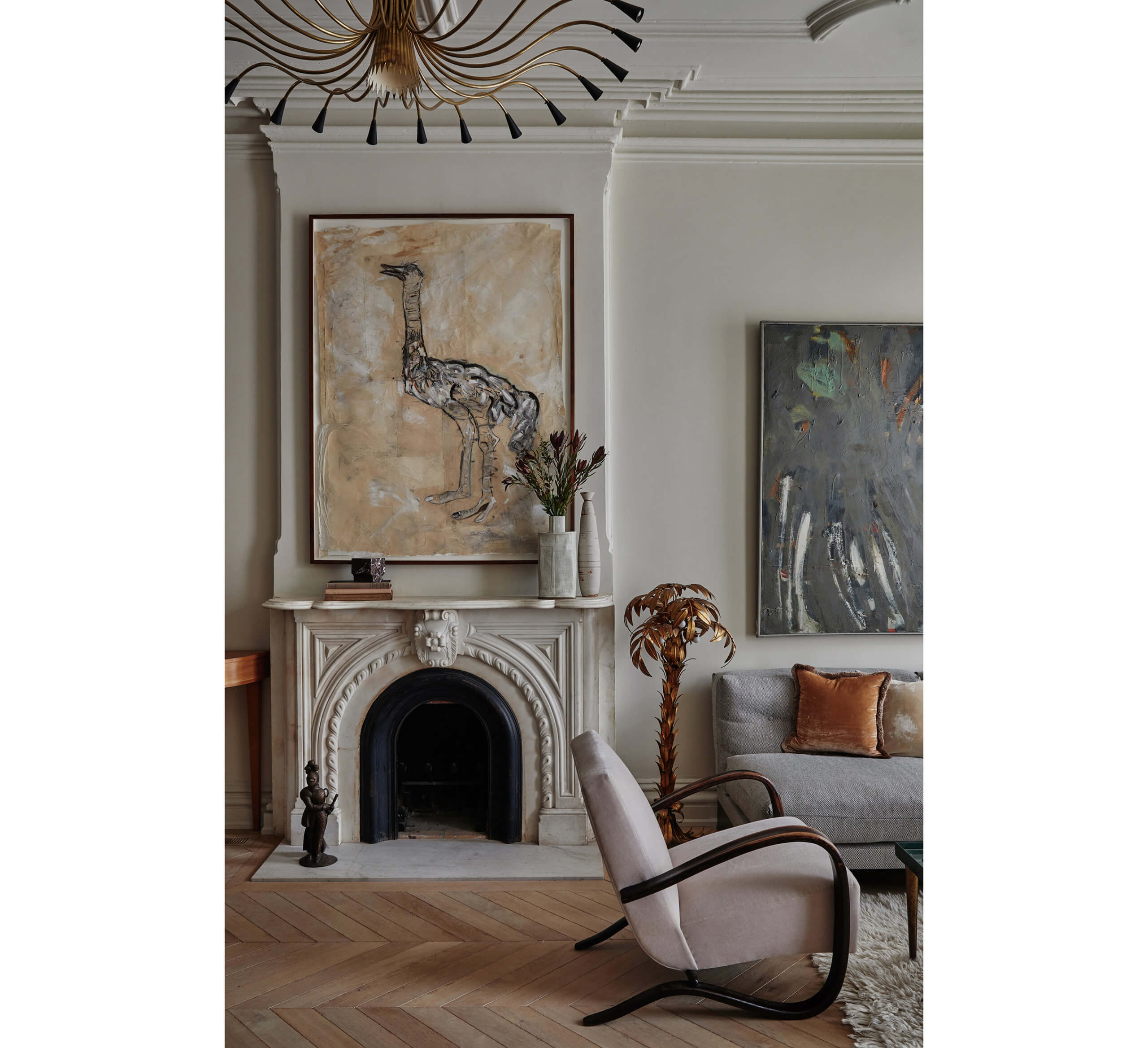 a parlor with an ostrich painting above a marble mantel