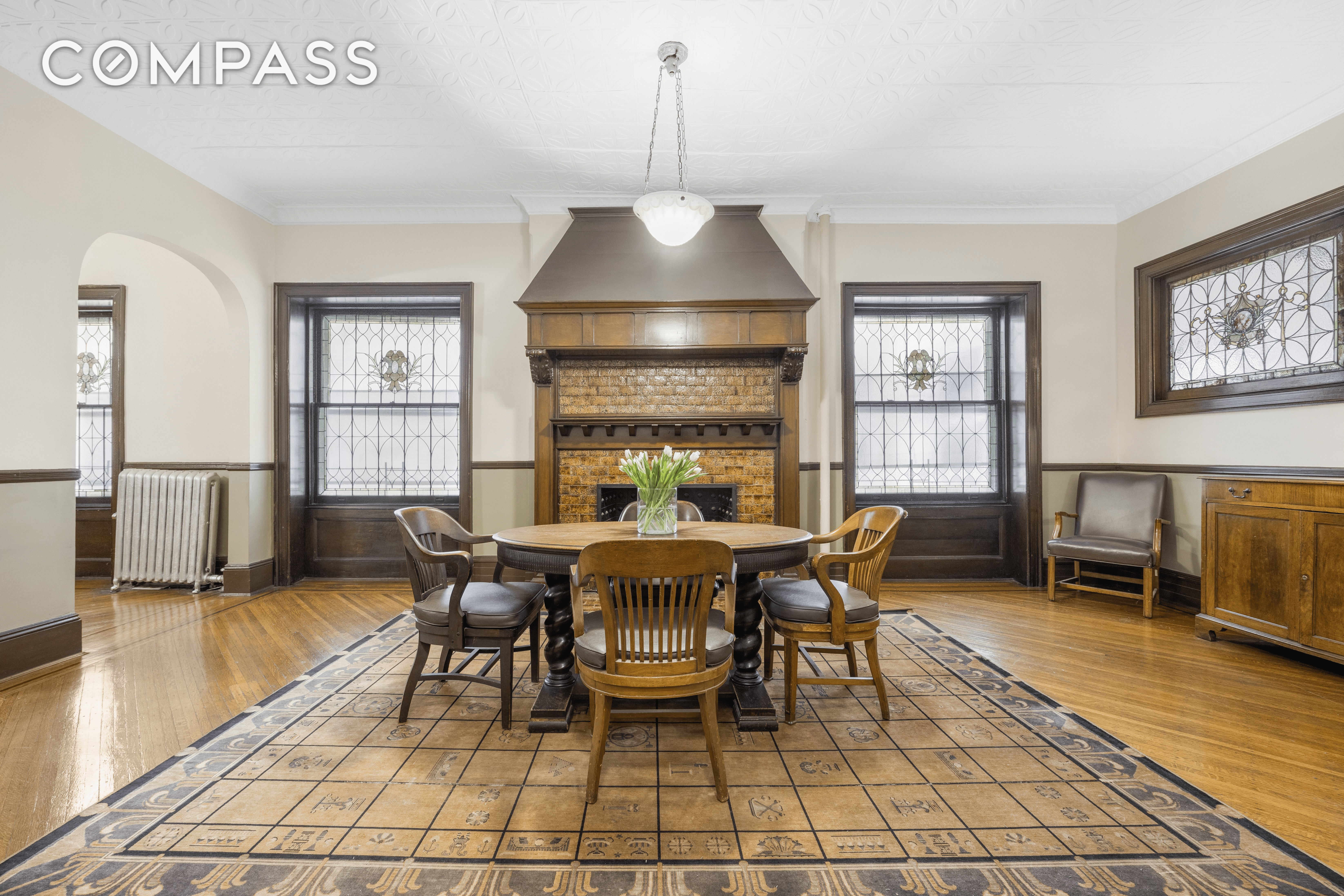 lobby with mantel and stained glass windows