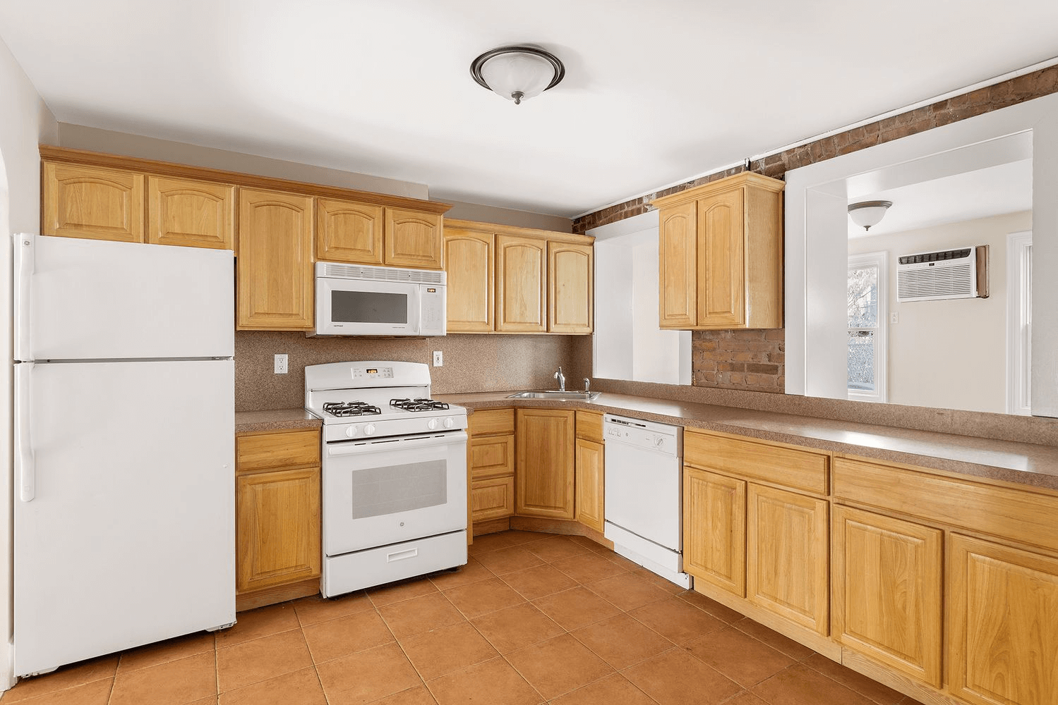 kitchen with tile floor and wood cabinets