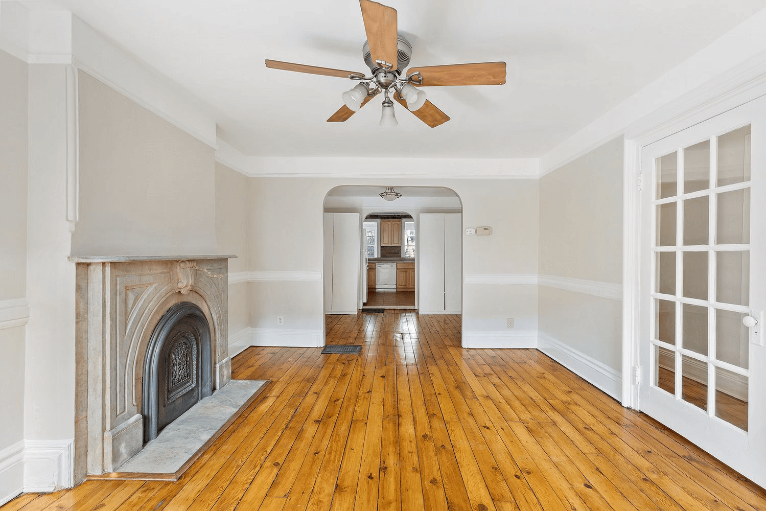 living room with ceiling fan and mantel