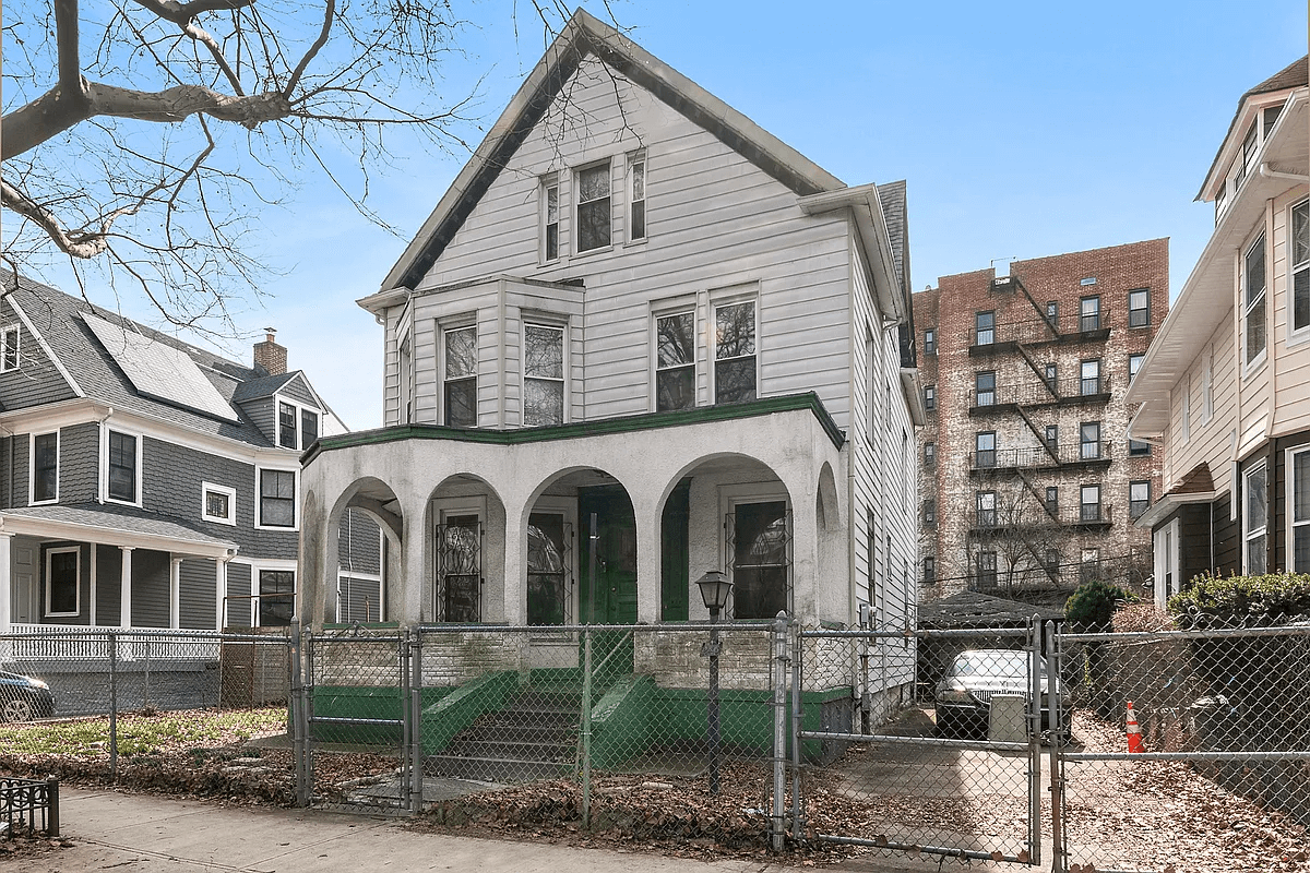 exterior of the house with chain link fence