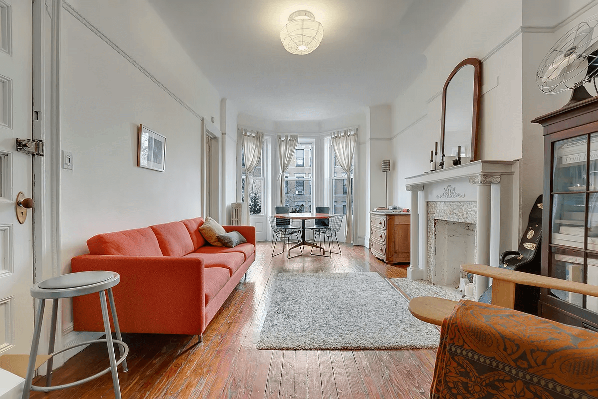 living room with mantel and bay window