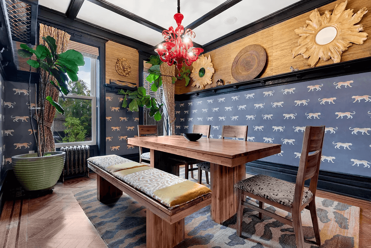 dining room with wallpaper and plate shelf