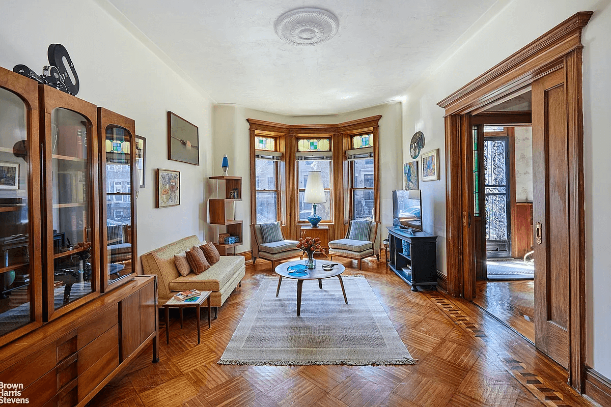 parlor with a bay window and pocket doors