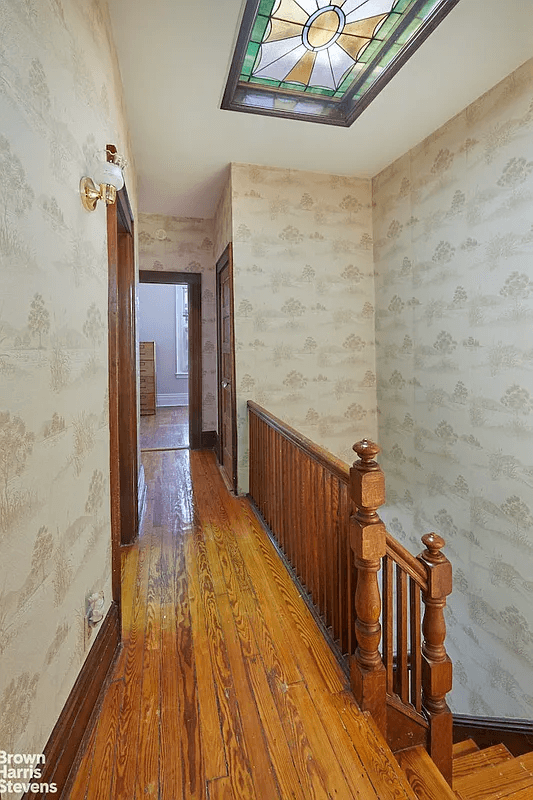 hall with stained glass skylight and wallpaper