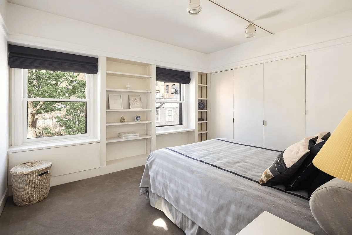 bedroom with built-in bookshelves