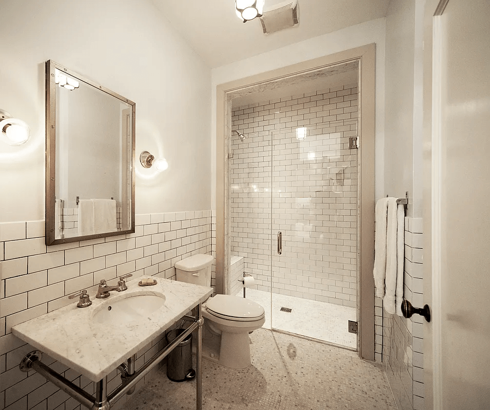bathroom with white subway tile and a shower