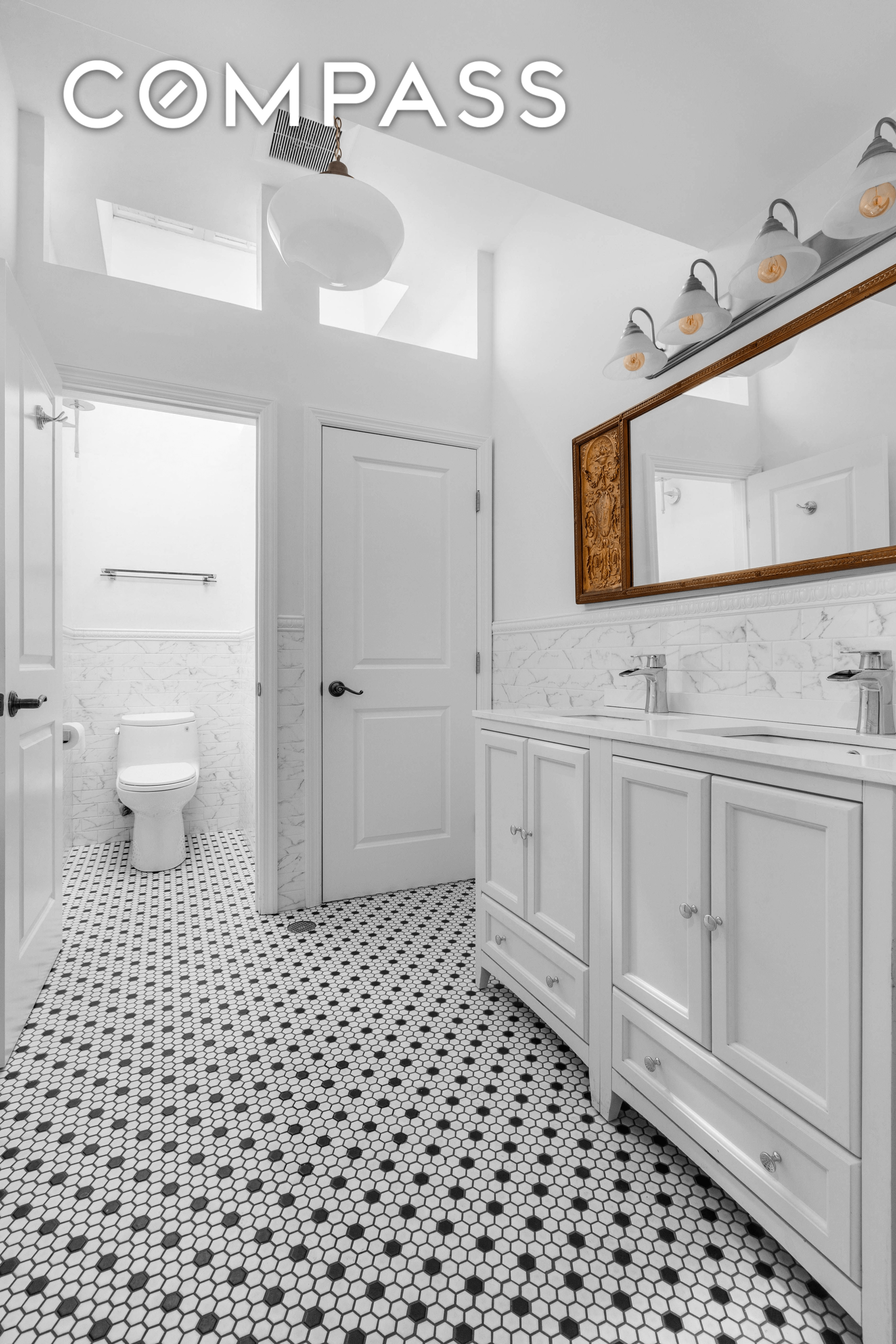 bathroom with hex tile black and white floor