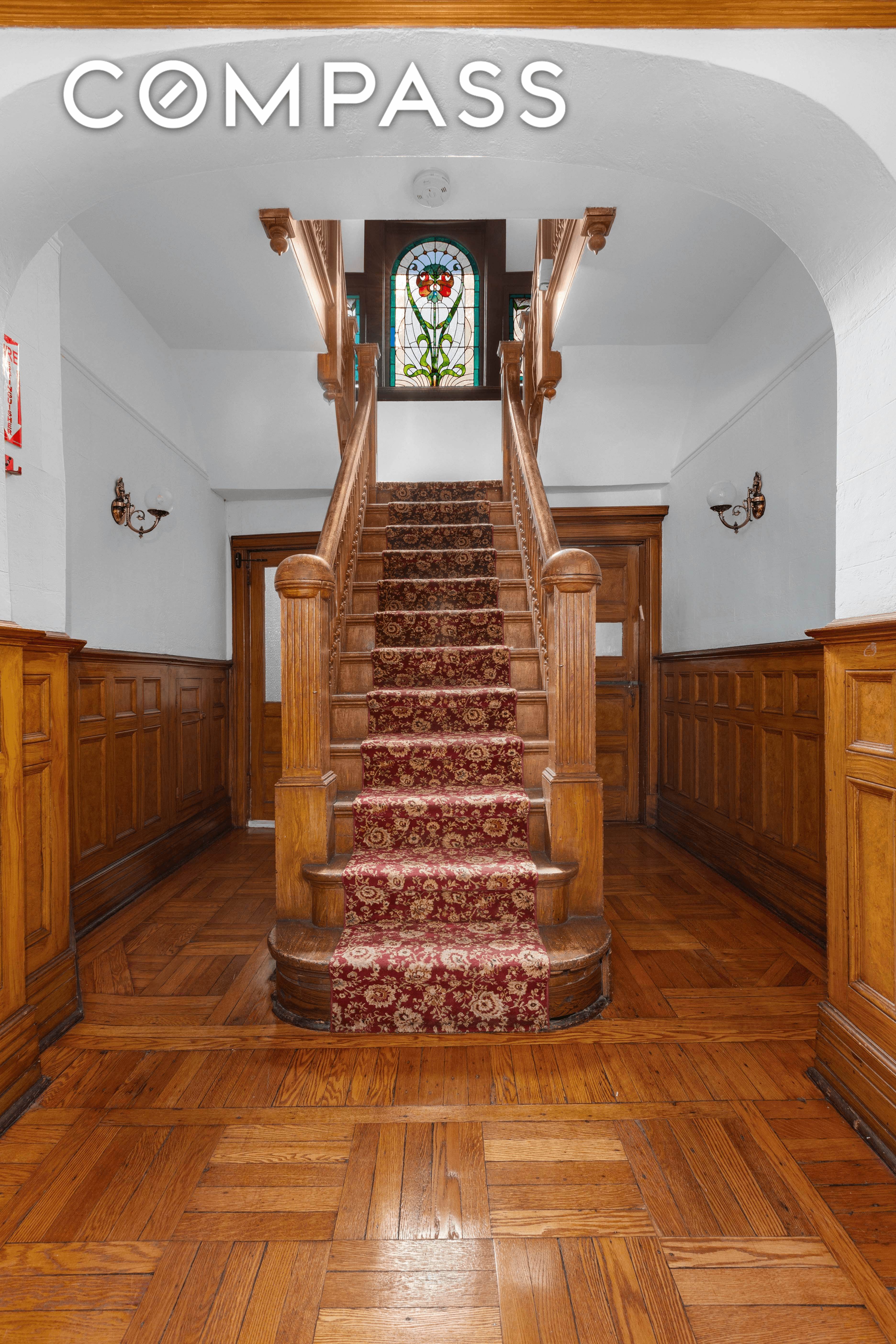 entry with staircase and stained glass window