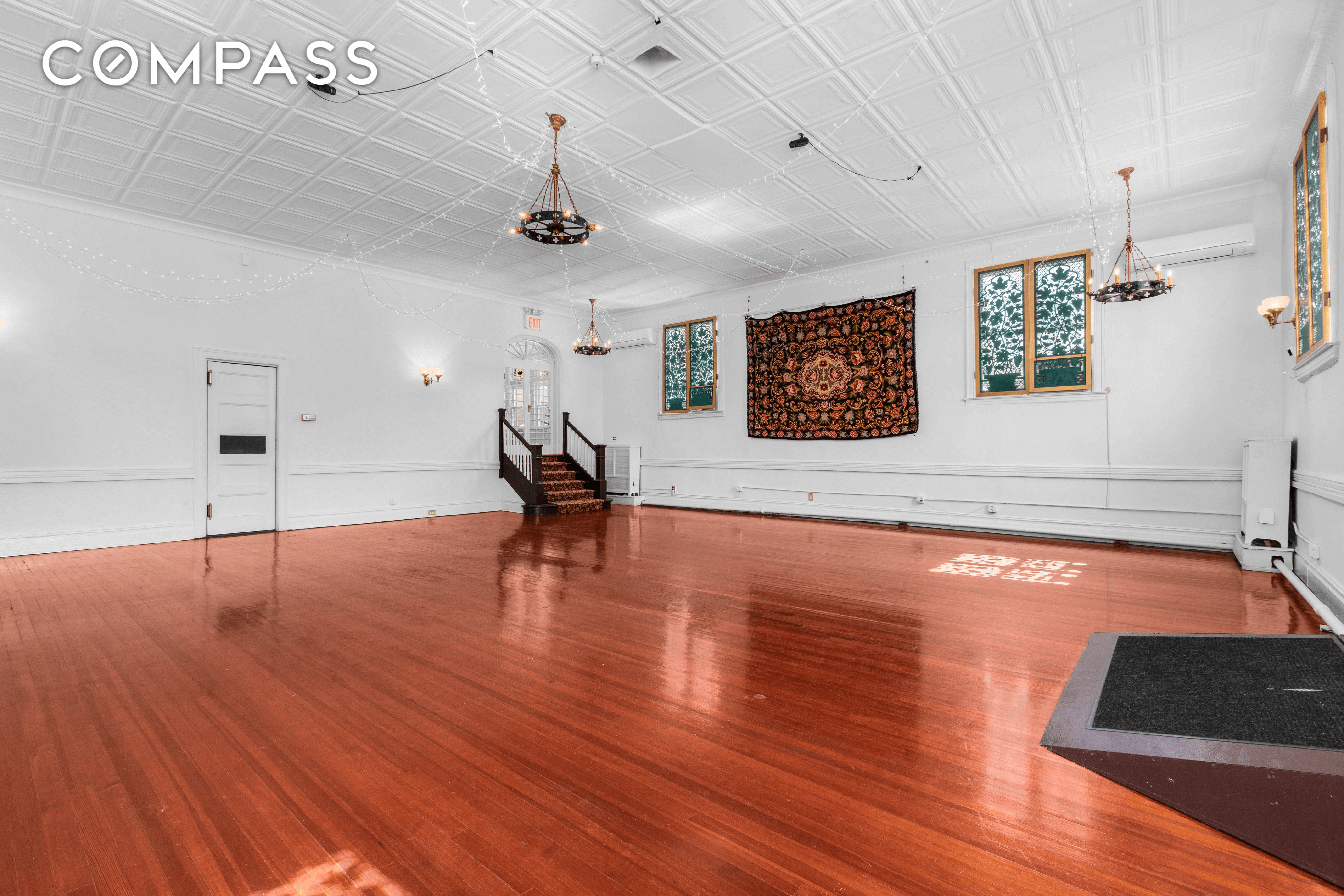 event space with tin ceiling and wood floor