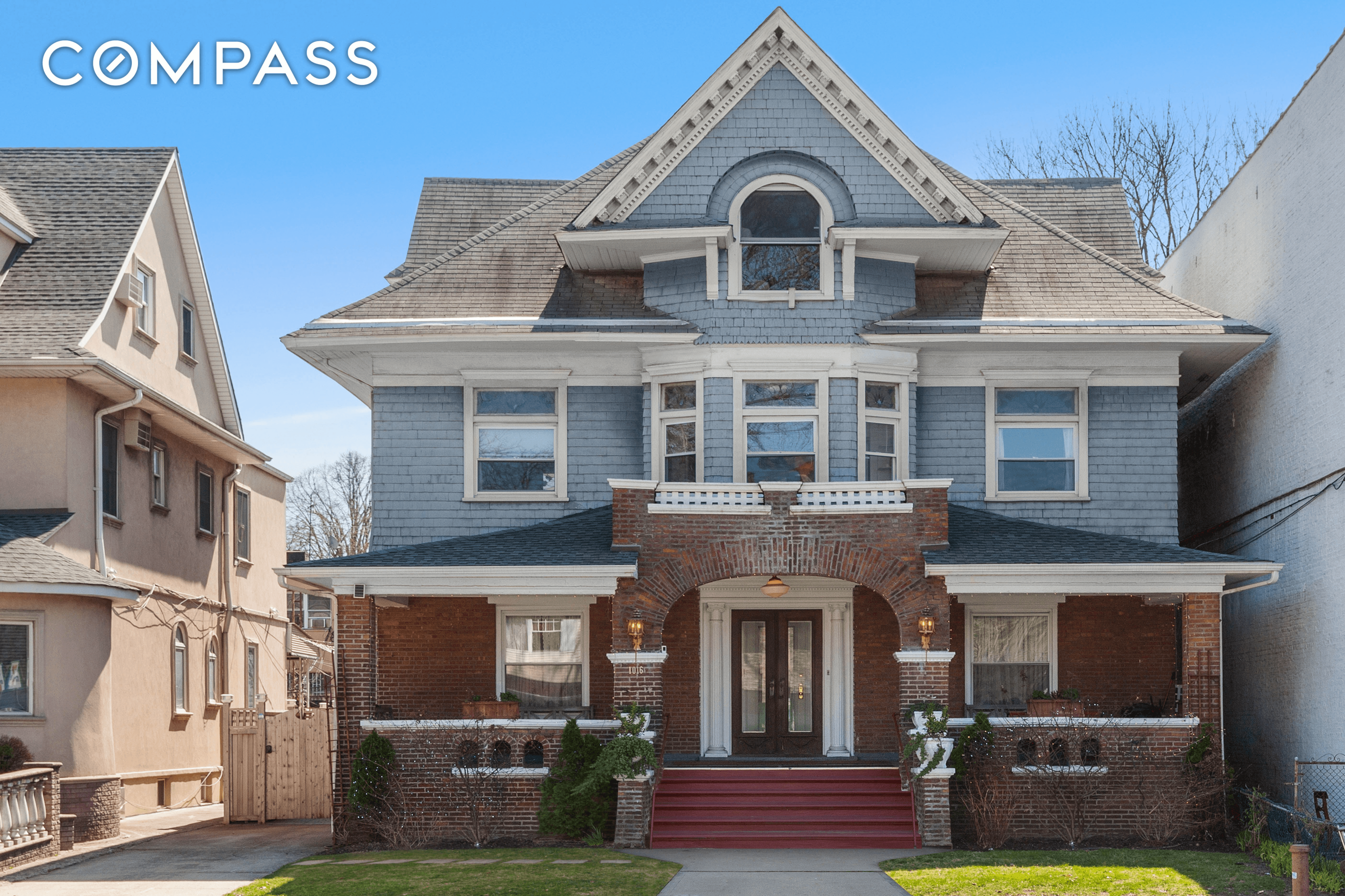 exterior of shingled house with brick porch