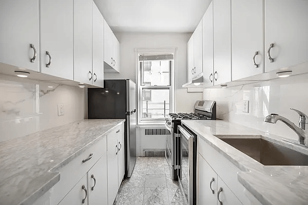 renovated kitchen with white cabinets