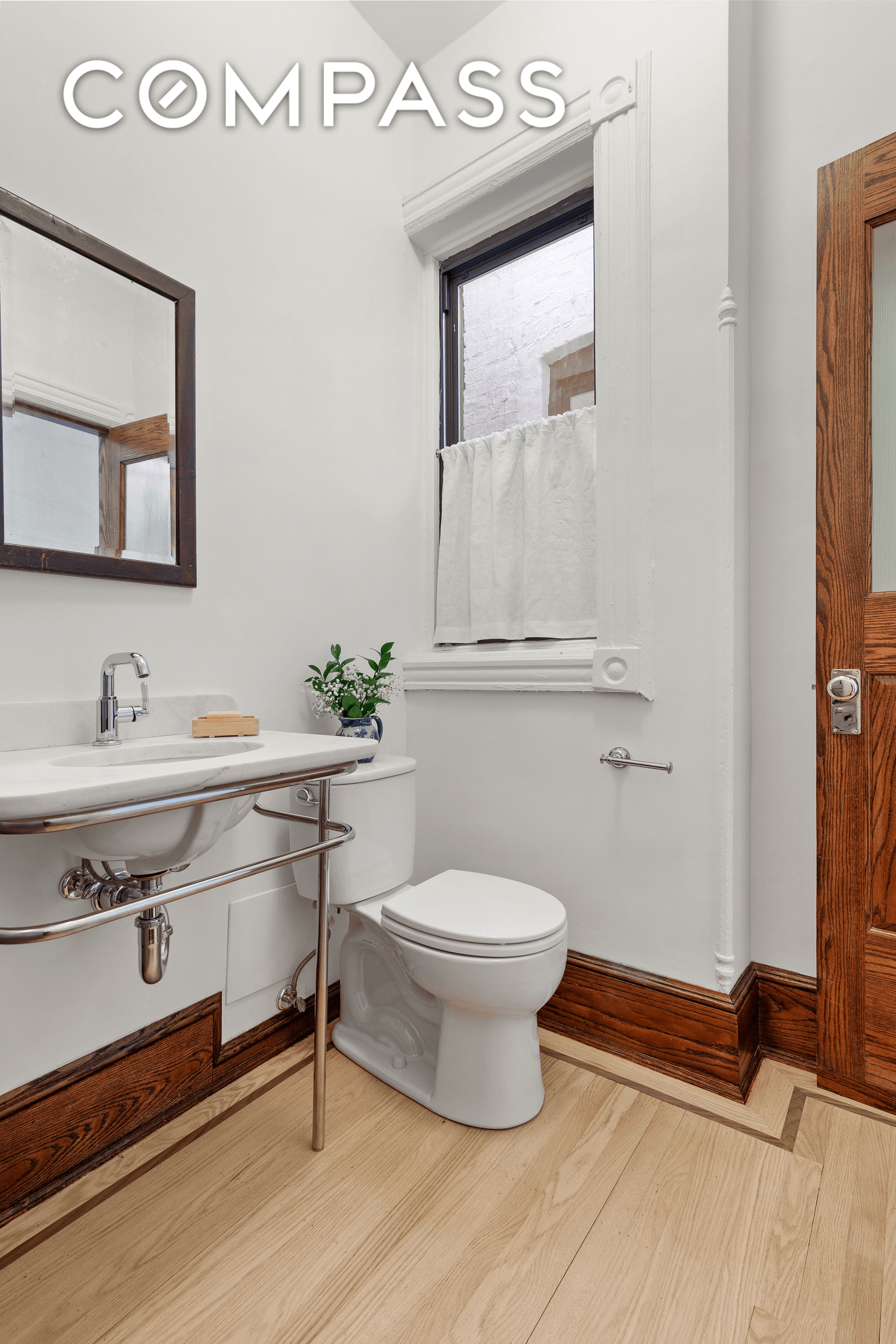 bathroom with marble sink and wood floor