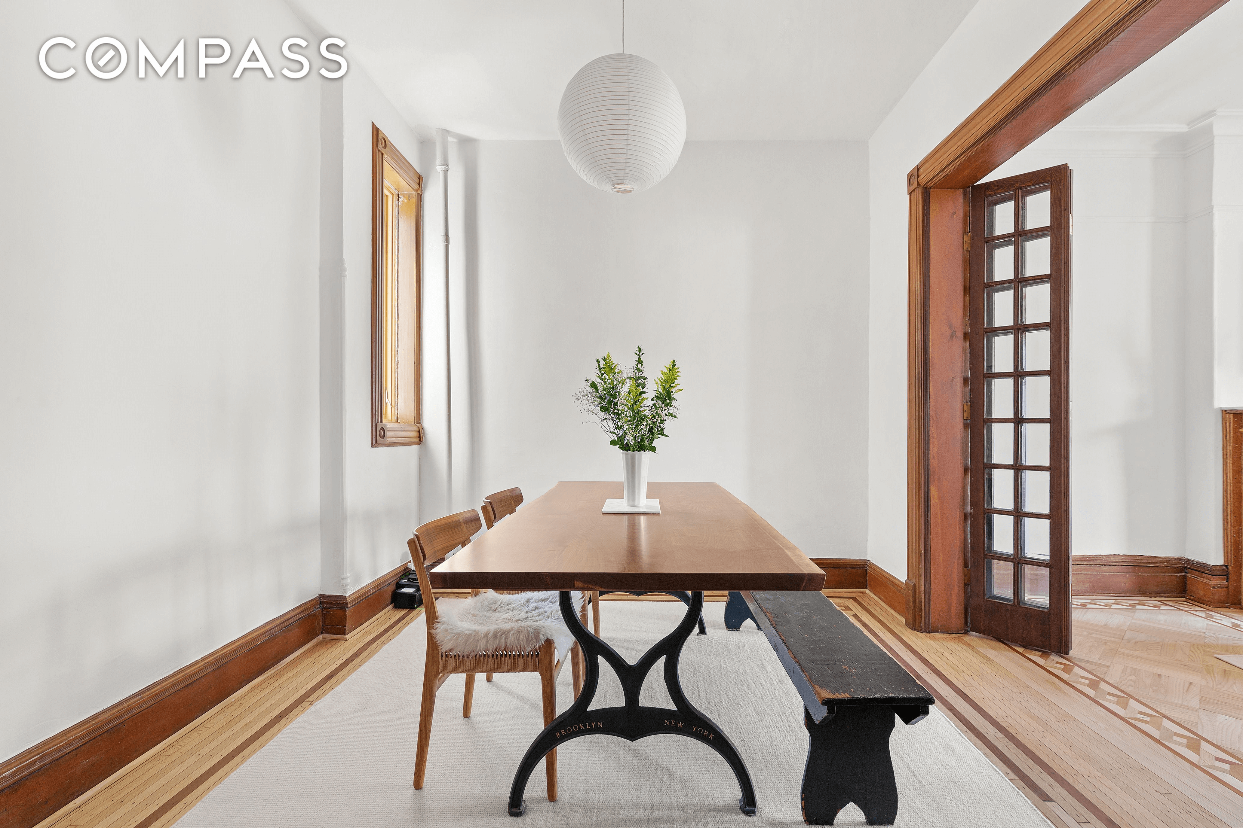 dining area with window and french doors into living room