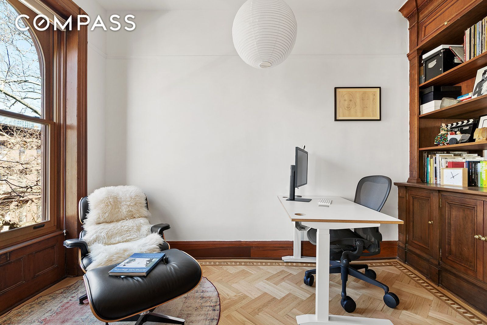 office with built-in book shelf and wood floors