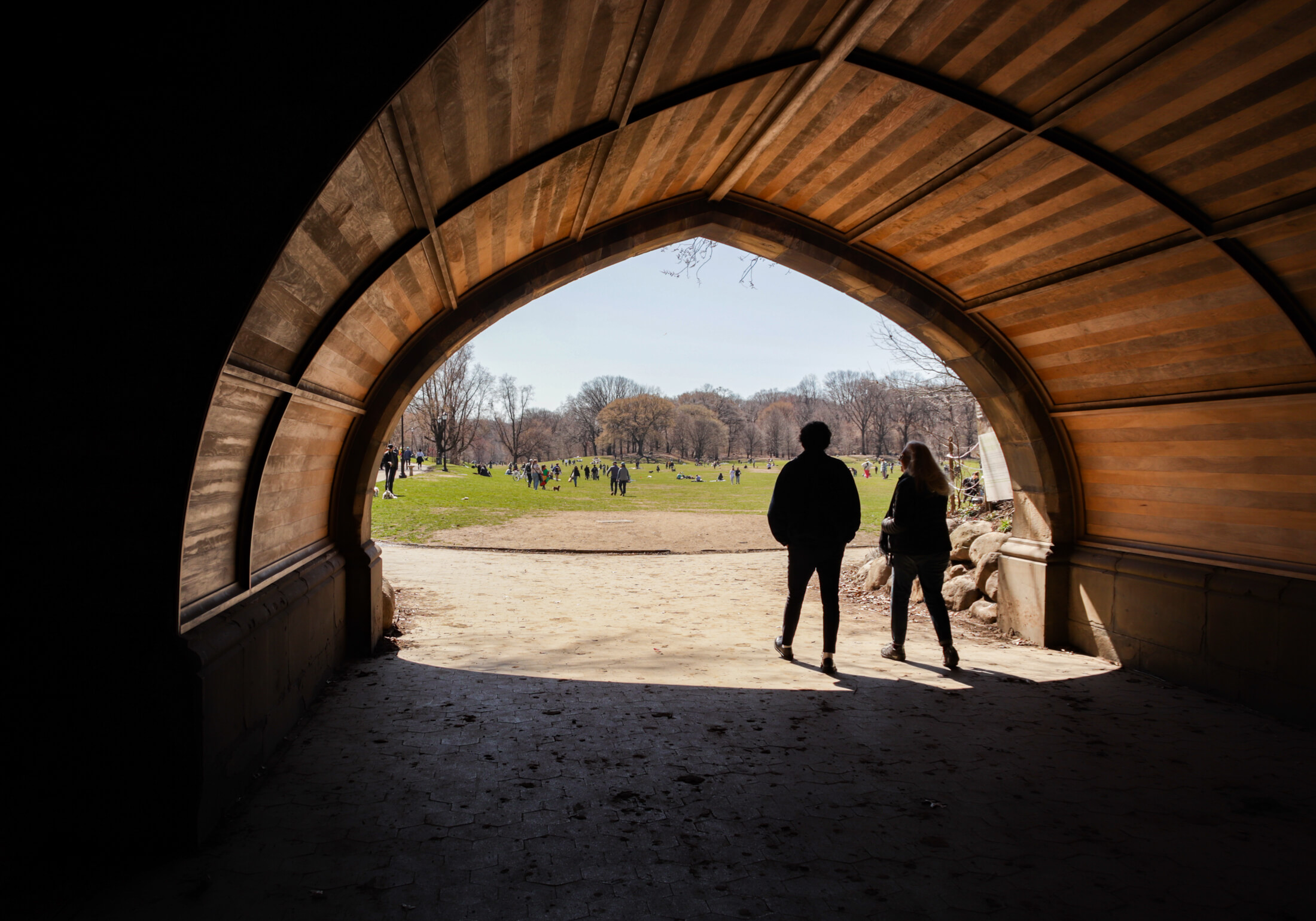 people walking through endale arch in prospect park