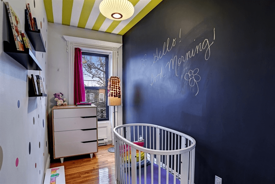 small bedroom with chalkboard wall