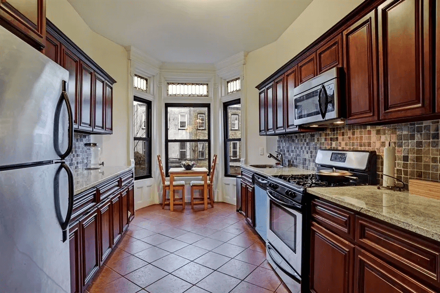 kitchen with tile floor and wood cabinets