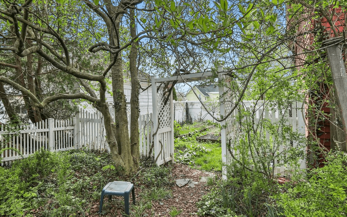 white picket fence and pergola in rear yard