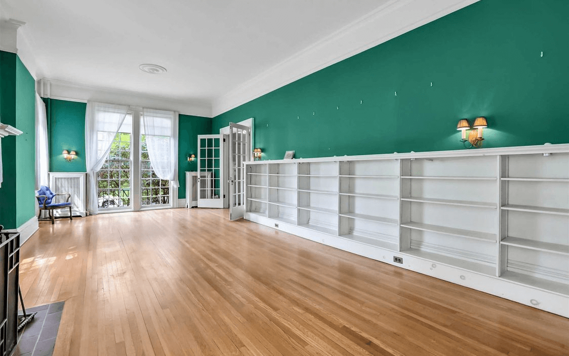 library with bookshelves and green walls