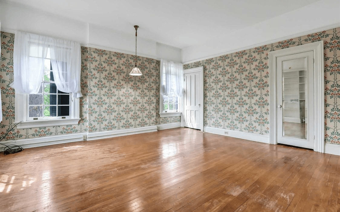 bedroom with wallpaper and wood floor