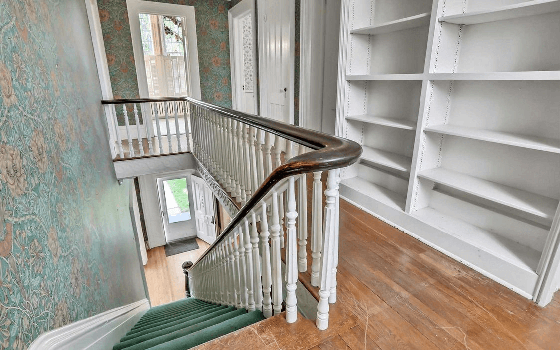 upstairs hallway with bookshelves