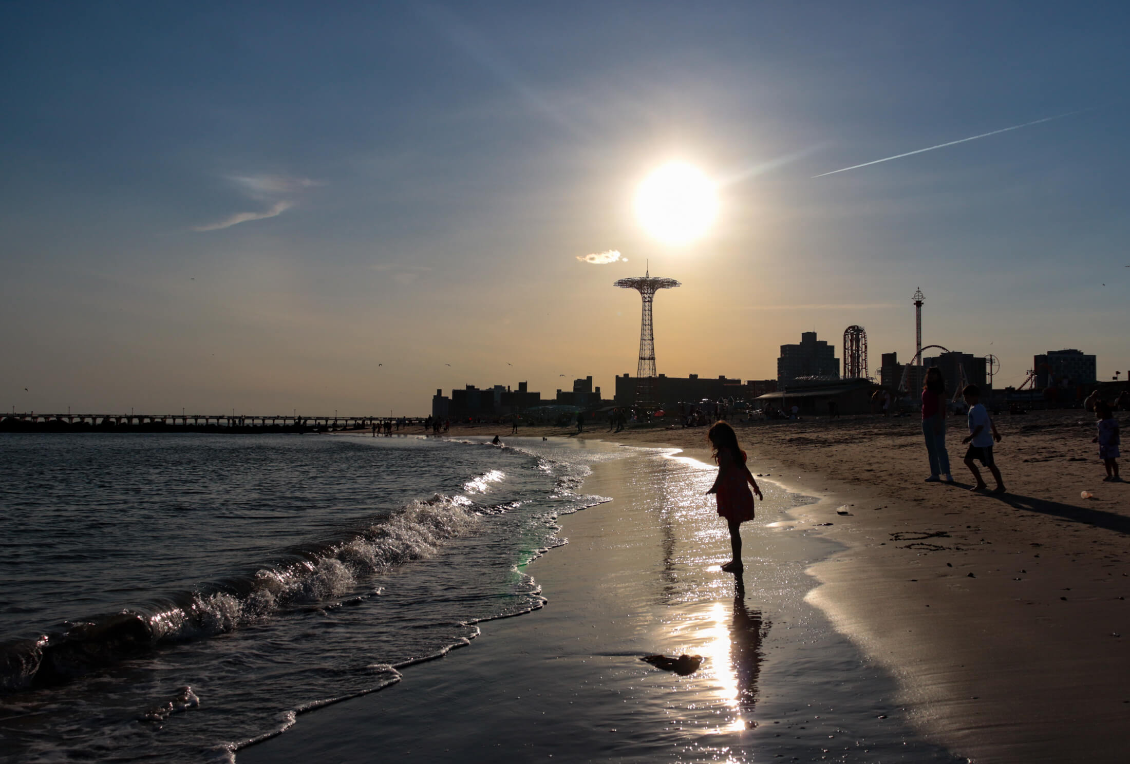 people on the beach near sunset