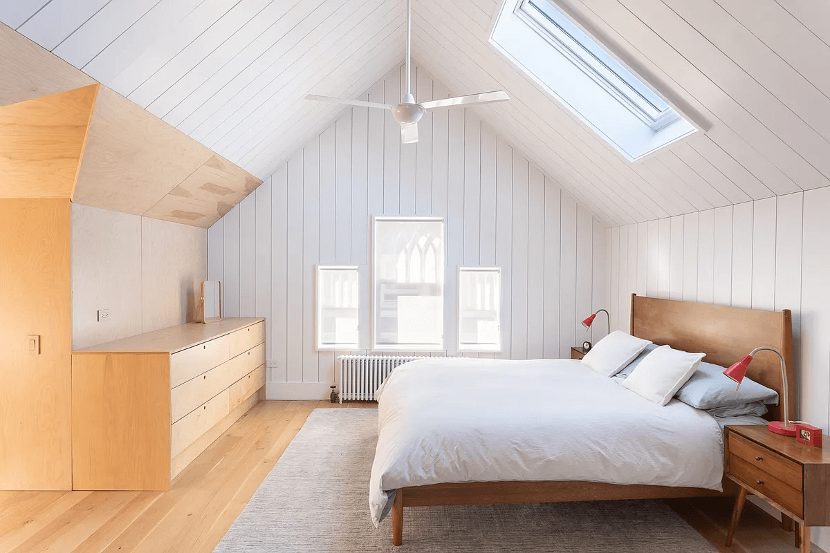 attic bedroom with wood paneling
