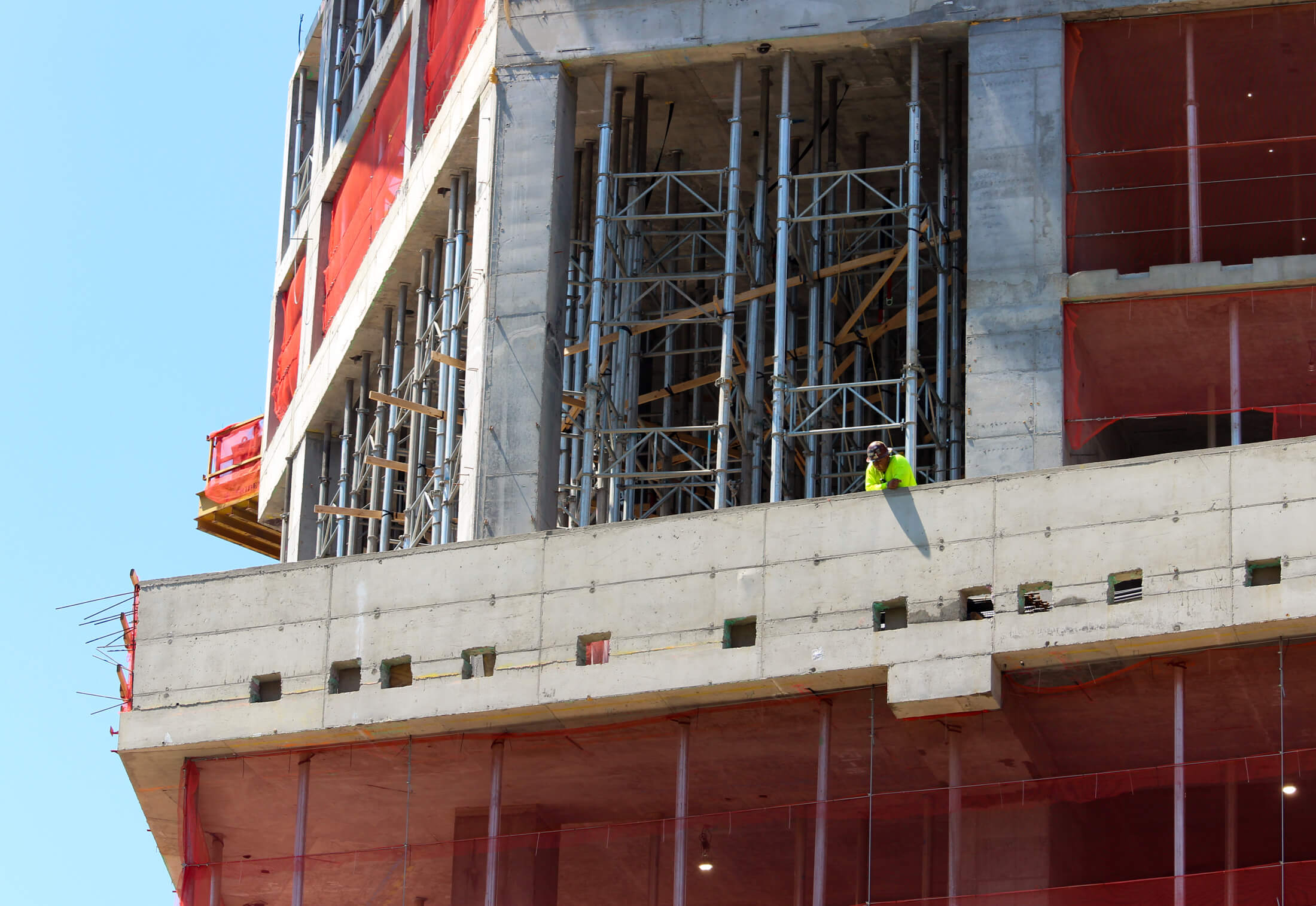 a construction worker looks down