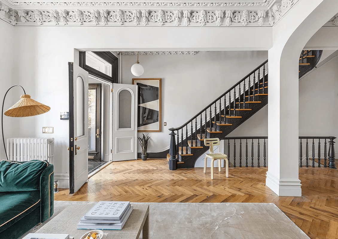 view of plasterwork in parlor and staircase with newel post